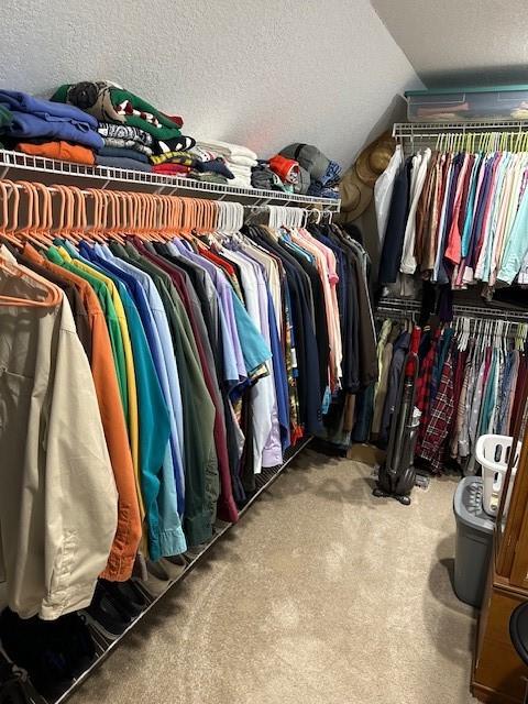 4017 160th St, Urbandale, IA 50323 - walk in closet featuring vaulted ceiling and carpet