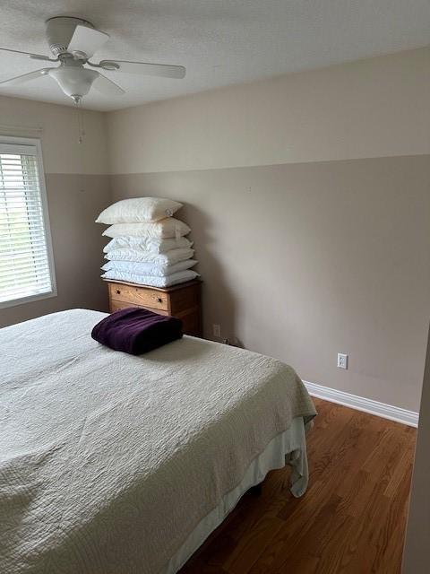 4017 160th St, Urbandale, IA 50323 - bedroom with wood finished floors and ceiling fan