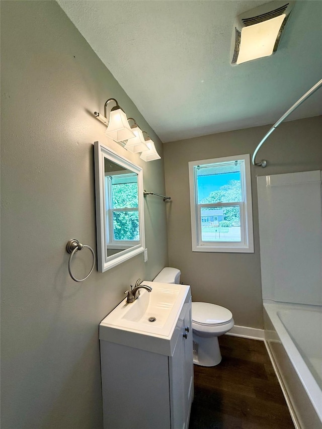 211 E Leach Ave, Des Moines, IA 50315 - bathroom featuring vanity, wood finished floors, and shower / tub combination
