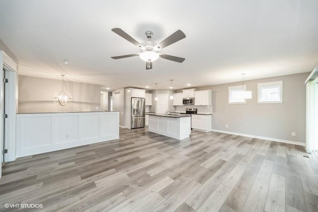112 Hickory Way, Polk City, IA 50226 - unfurnished living room featuring ceiling fan, light wood-style floors, a chandelier, and recessed lighting
