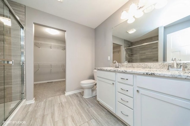 112 Hickory Way, Polk City, IA 50226 - bathroom featuring a shower stall, double vanity, and a spacious closet