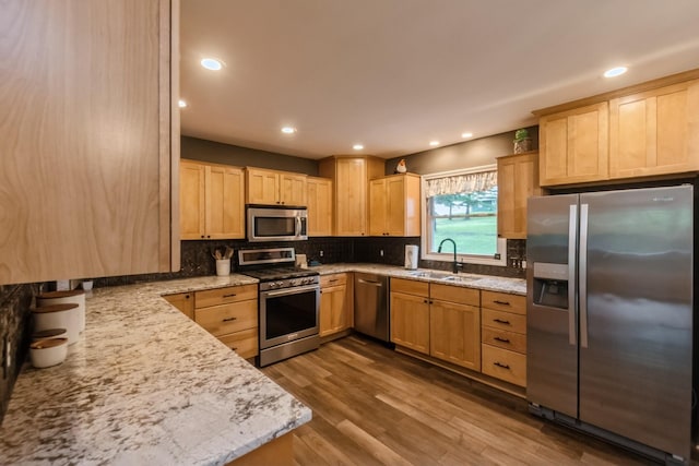 310 SE 3rd St, Panora, IA 50216 - kitchen with appliances with stainless steel finishes, light brown cabinetry, decorative backsplash, dark wood-style flooring, and light stone counters