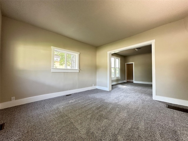 507 W Lincoln Way, Jefferson, IA 50129 - unfurnished room with baseboards and dark colored carpet