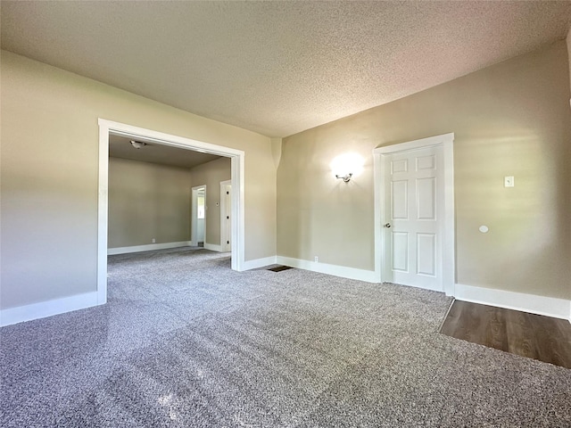 507 W Lincoln Way, Jefferson, IA 50129 - carpeted empty room with baseboards and a textured ceiling