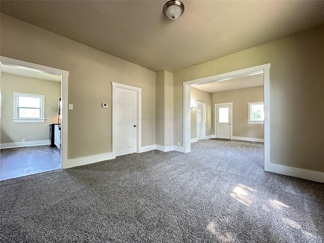 507 W Lincoln Way, Jefferson, IA 50129 - unfurnished room with dark colored carpet and baseboards