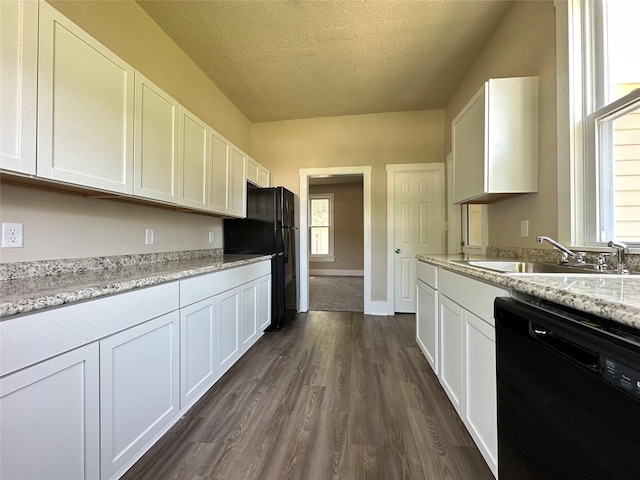 507 W Lincoln Way, Jefferson, IA 50129 - kitchen with black appliances, dark wood-style flooring, white cabinets, and a textured ceiling