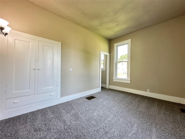 507 W Lincoln Way, Jefferson, IA 50129 - carpeted empty room with a textured ceiling and baseboards