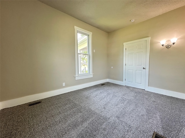 507 W Lincoln Way, Jefferson, IA 50129 - spare room with dark carpet and a smoke detector