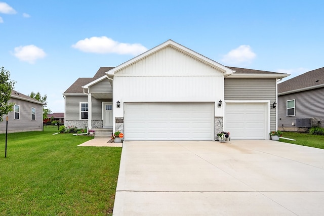 1200 Joshua Dr SE, Bondurant, IA 50035 - view of front of property with a garage, concrete driveway, a front lawn, and stone siding