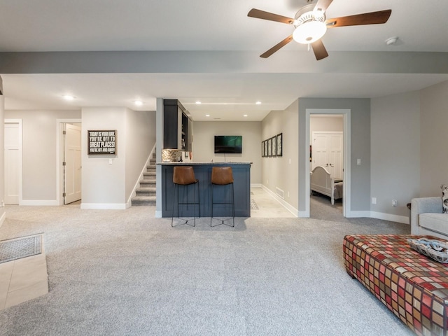 16530 Valleyview Ln, Clive, IA 50325 - living room featuring light carpet, a ceiling fan, bar area, stairs, and recessed lighting