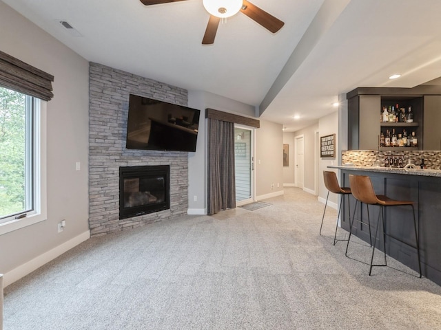16530 Valleyview Ln, Clive, IA 50325 - living area featuring a dry bar, a ceiling fan, light carpet, a fireplace, and recessed lighting