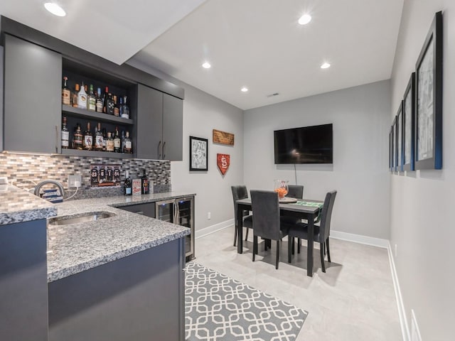 16530 Valleyview Ln, Clive, IA 50325 - indoor wet bar with beverage cooler, decorative backsplash, and recessed lighting