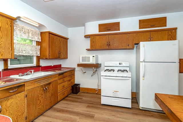 213 S Wilmoth Ave, Ames, IA 50014 - kitchen with white appliances, brown cabinetry, and light wood-type flooring