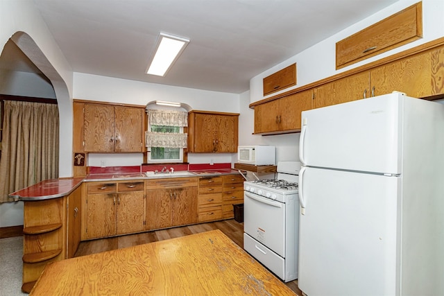213 S Wilmoth Ave, Ames, IA 50014 - kitchen featuring white appliances, brown cabinetry, open shelves, light wood-type flooring, and a peninsula