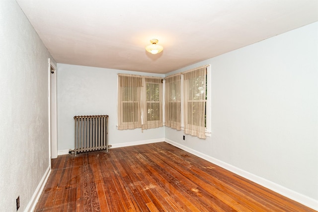 213 S Wilmoth Ave, Ames, IA 50014 - spare room with radiator heating unit and hardwood / wood-style floors