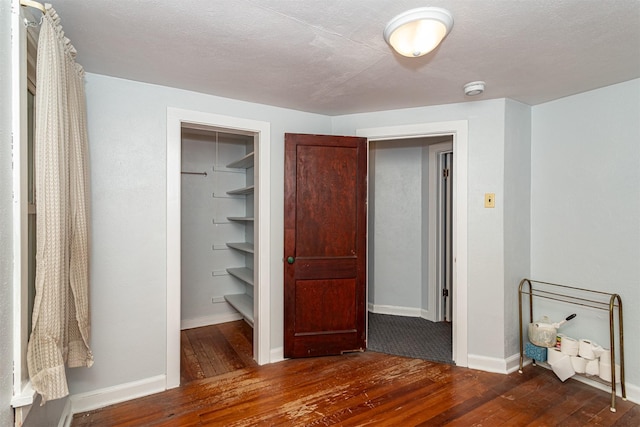 213 S Wilmoth Ave, Ames, IA 50014 - unfurnished bedroom featuring hardwood / wood-style floors, a walk in closet, and a closet