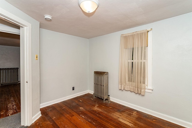 213 S Wilmoth Ave, Ames, IA 50014 - spare room with radiator, wood-type flooring, and a smoke detector