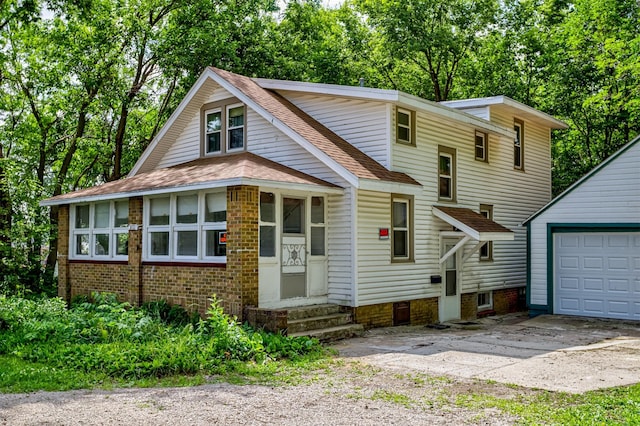 213 S Wilmoth Ave, Ames, IA 50014 - view of front facade featuring concrete driveway, a shingled roof, entry steps, a garage, and an outbuilding