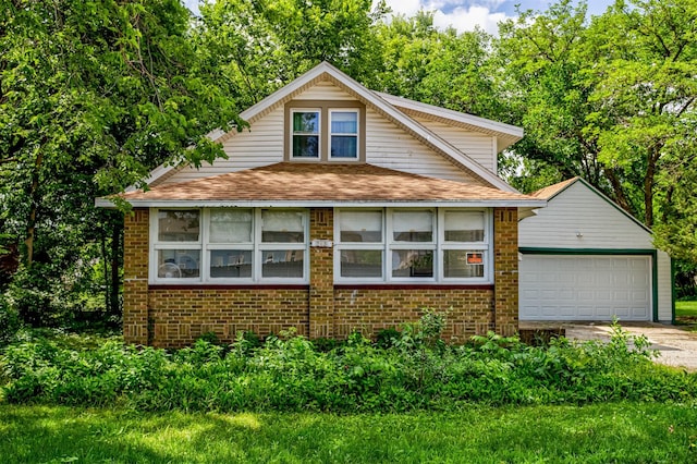 213 S Wilmoth Ave, Ames, IA 50014 - bungalow-style house with brick siding, concrete driveway, and a shingled roof