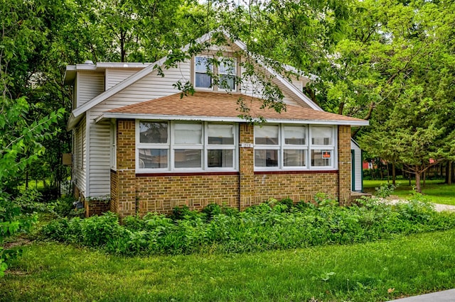 213 S Wilmoth Ave, Ames, IA 50014 - view of side of home with brick siding and roof with shingles