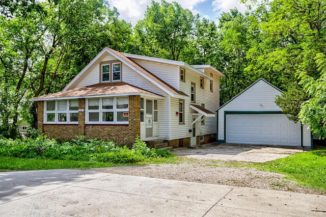 213 S Wilmoth Ave, Ames, IA 50014 - view of front of property featuring an outbuilding, a garage, brick siding, and a shingled roof