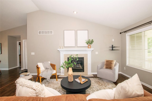 408 Tailfeather Ct NW, Bondurant, IA 50035 - living area featuring vaulted ceiling, wood finished floors, and a tiled fireplace
