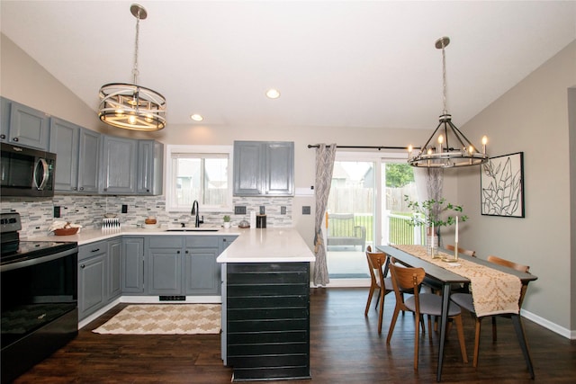 408 Tailfeather Ct NW, Bondurant, IA 50035 - kitchen with a chandelier, black range with electric cooktop, stainless steel microwave, gray cabinetry, and lofted ceiling
