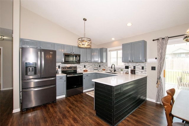408 Tailfeather Ct NW, Bondurant, IA 50035 - kitchen featuring appliances with stainless steel finishes, gray cabinetry, a peninsula, a chandelier, and tasteful backsplash