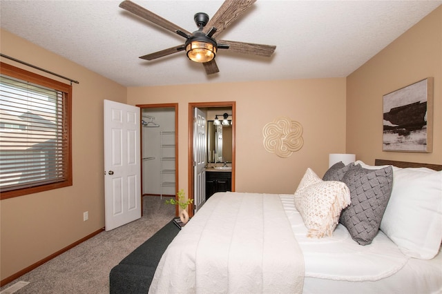 408 Tailfeather Ct NW, Bondurant, IA 50035 - bedroom with carpet floors, ensuite bath, ceiling fan, and a spacious closet