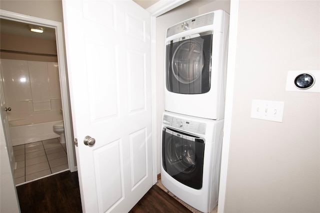 408 Tailfeather Ct NW, Bondurant, IA 50035 - laundry area with estacked washer and dryer and dark wood-style floors