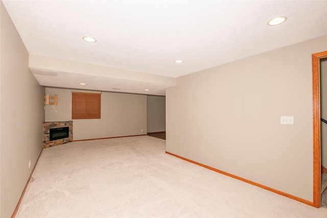 408 Tailfeather Ct NW, Bondurant, IA 50035 - unfurnished living room with light colored carpet, recessed lighting, and a stone fireplace
