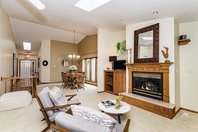 4012 Fletcher Blvd, Ames, IA 50010 - living area featuring light colored carpet, a glass covered fireplace, lofted ceiling, a chandelier, and a skylight
