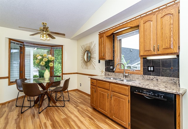 4012 Fletcher Blvd, Ames, IA 50010 - kitchen featuring black dishwasher, light wood-style flooring, vaulted ceiling, decorative backsplash, and ceiling fan