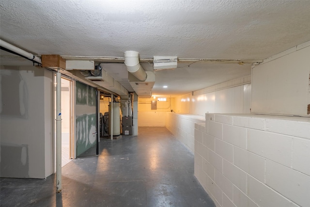 1115 E Herold Ave, Des Moines, IA 50315 - unfinished basement with electric panel, concrete block wall, water heater, and a textured ceiling
