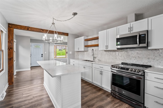 1115 E Herold Ave, Des Moines, IA 50315 - kitchen featuring stainless steel appliances, open shelves, decorative backsplash, and light countertops