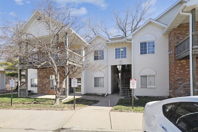 2547 Patricia Dr, Urbandale, IA 50322 - multi unit property with a balcony, brick siding, and stairway