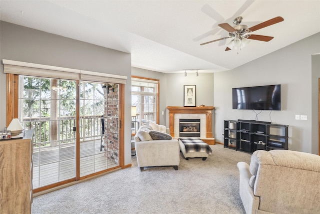 2547 Patricia Dr, Urbandale, IA 50322 - carpeted living area with a ceiling fan, a fireplace, and vaulted ceiling