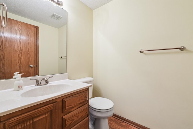 2547 Patricia Dr, Urbandale, IA 50322 - bathroom featuring vanity, wood finished floors, and a textured ceiling