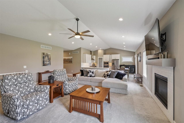 10214 Thorne Dr, West Des Moines, IA 50266 - living area with vaulted ceiling, a brick fireplace, a ceiling fan, light carpet, and recessed lighting