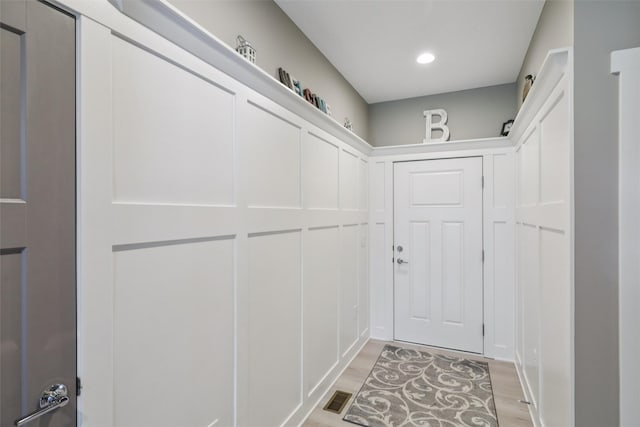 10214 Thorne Dr, West Des Moines, IA 50266 - doorway with light wood-style floors and recessed lighting