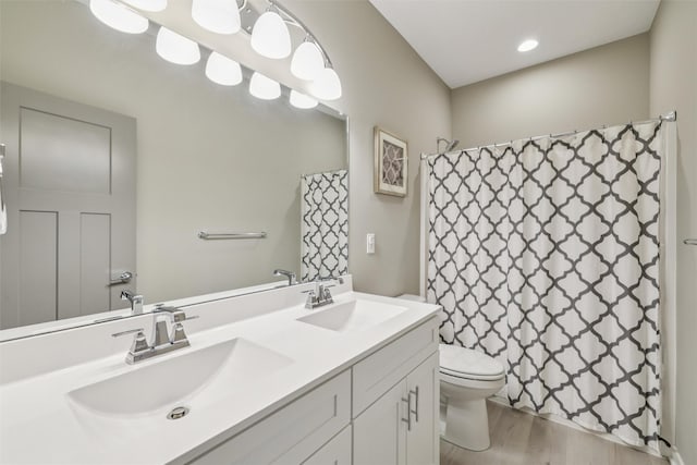 10214 Thorne Dr, West Des Moines, IA 50266 - full bathroom with double vanity, a shower with curtain, and wood finished floors