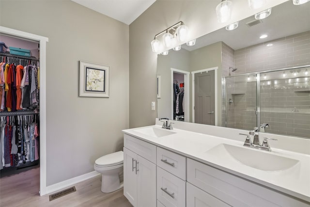 10214 Thorne Dr, West Des Moines, IA 50266 - full bath featuring double vanity, a spacious closet, wood finished floors, and a stall shower