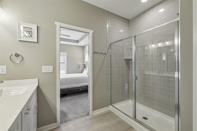10214 Thorne Dr, West Des Moines, IA 50266 - ensuite bathroom featuring wood finished floors, a shower stall, vanity, and recessed lighting