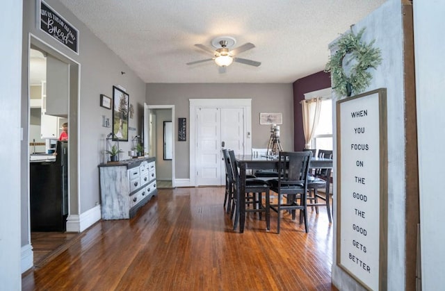 314 E 3rd St N, Newton, IA 50208 - dining space featuring dark wood-style floors, ceiling fan, and a textured ceiling