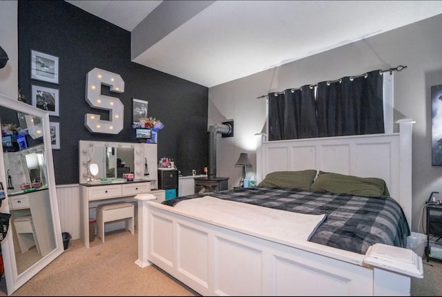 314 E 3rd St N, Newton, IA 50208 - bedroom with light carpet and a wood stove