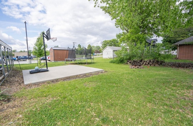 314 E 3rd St N, Newton, IA 50208 - view of grassy yard featuring a trampoline, a shed, and a patio area