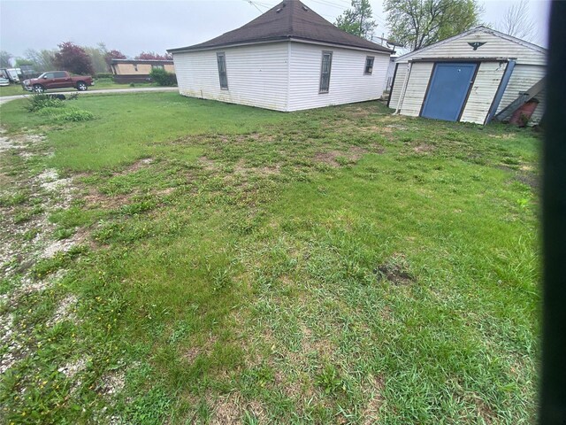 204 Missouri Ave, Lorimor, IA 50149 - view of grassy yard with a storage shed