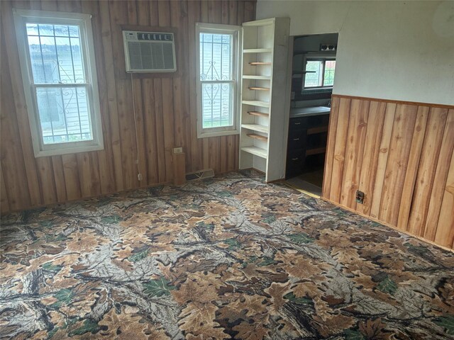 204 Missouri Ave, Lorimor, IA 50149 - unfurnished room featuring wood walls and an AC wall unit