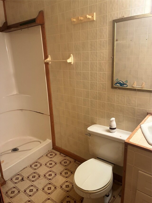 204 Missouri Ave, Lorimor, IA 50149 - full bathroom featuring a shower stall, tile walls, and vanity