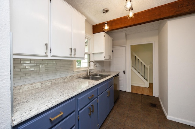 1144 57th St, Des Moines, IA 50311 - kitchen featuring blue cabinetry, white cabinets, tasteful backsplash, light countertops, and stainless steel dishwasher